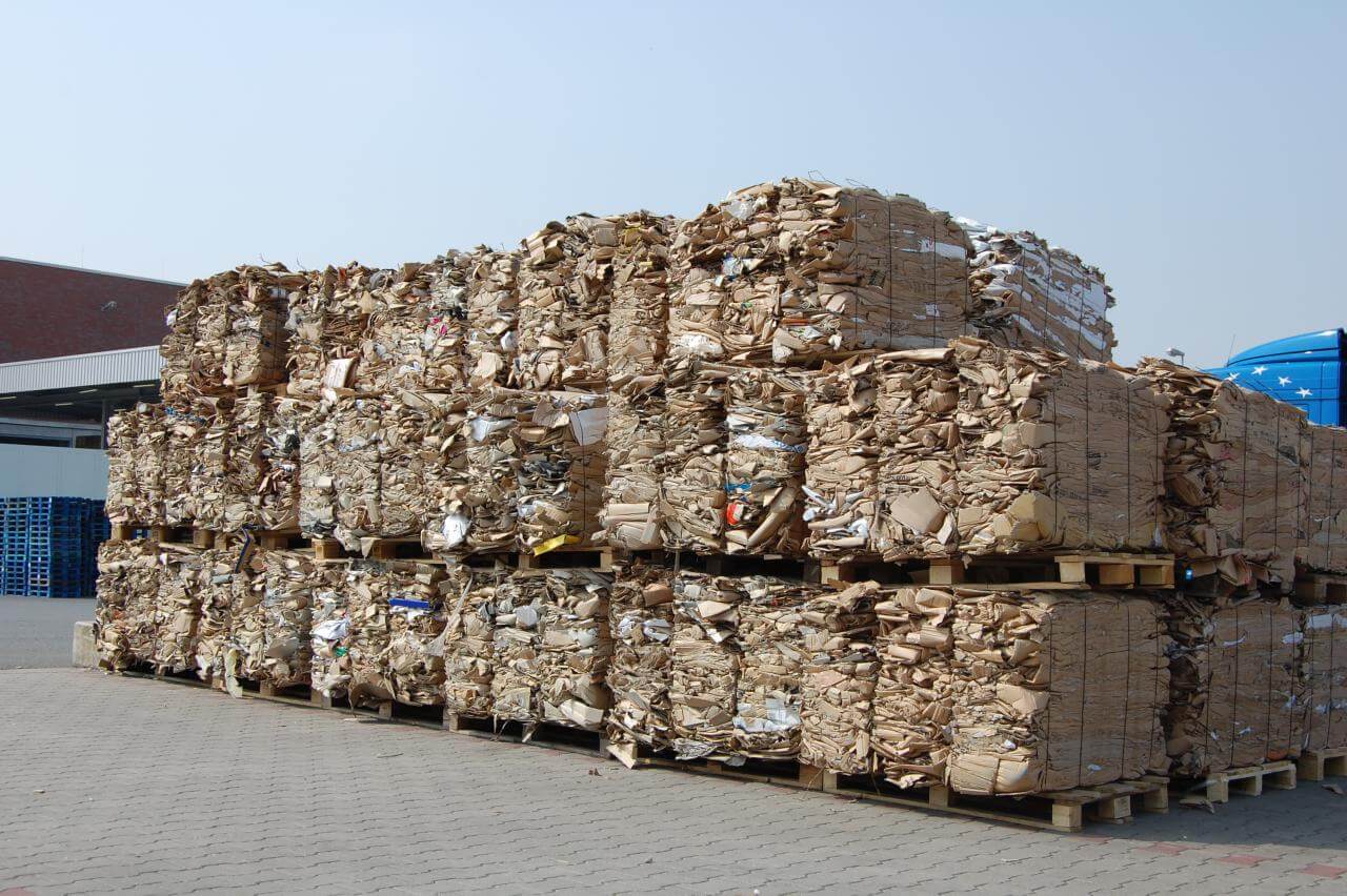 A pile of recycled cardboards in a recycling center